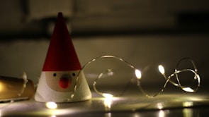 A classic character figure displayed on a wooden shelf with soft lighting.