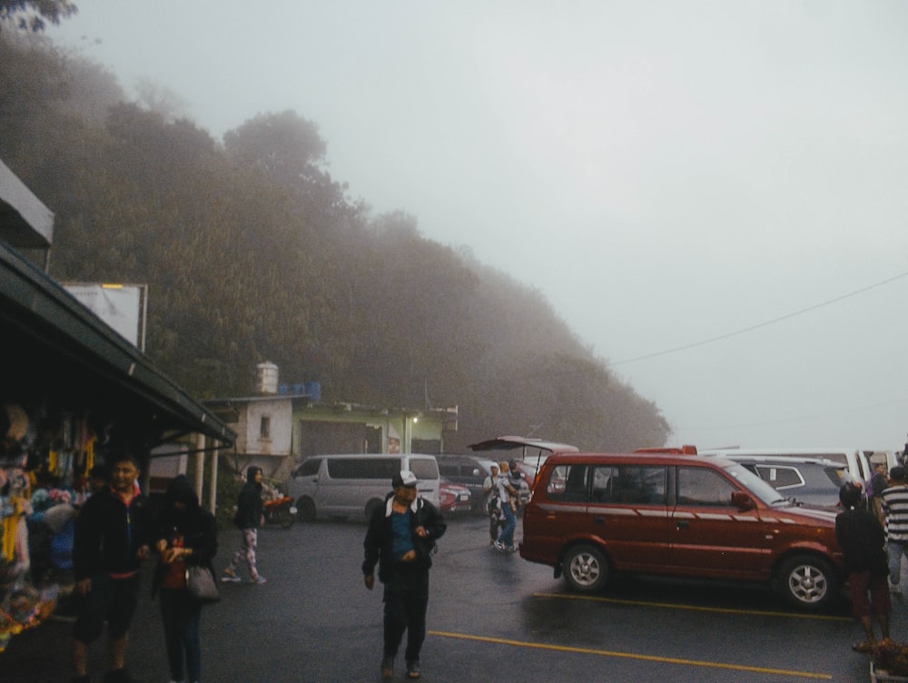 a group of people standing in a parking lot