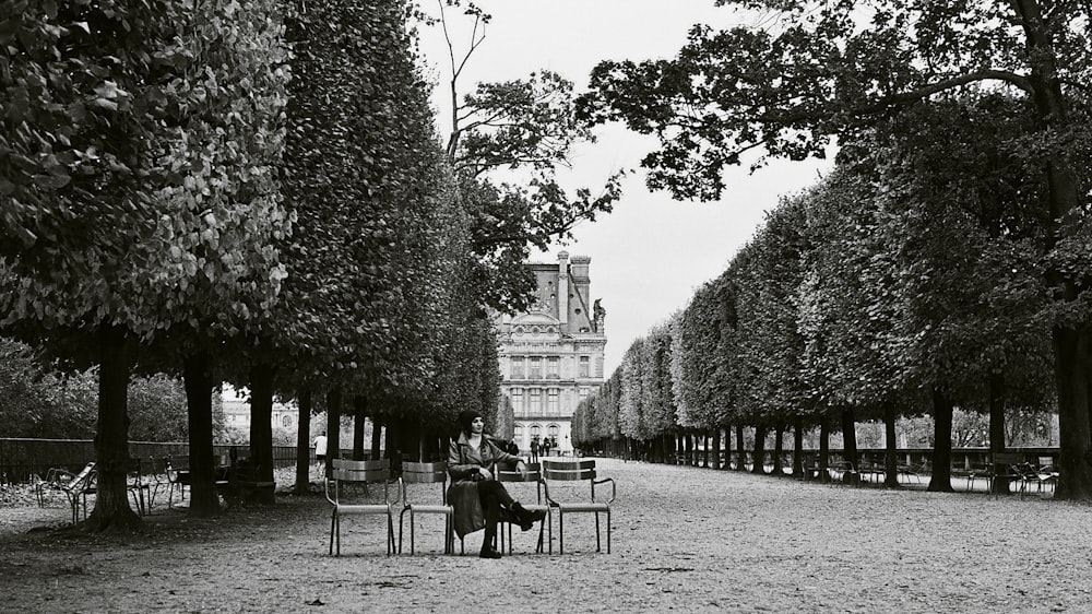 a woman sitting on a bench in a park