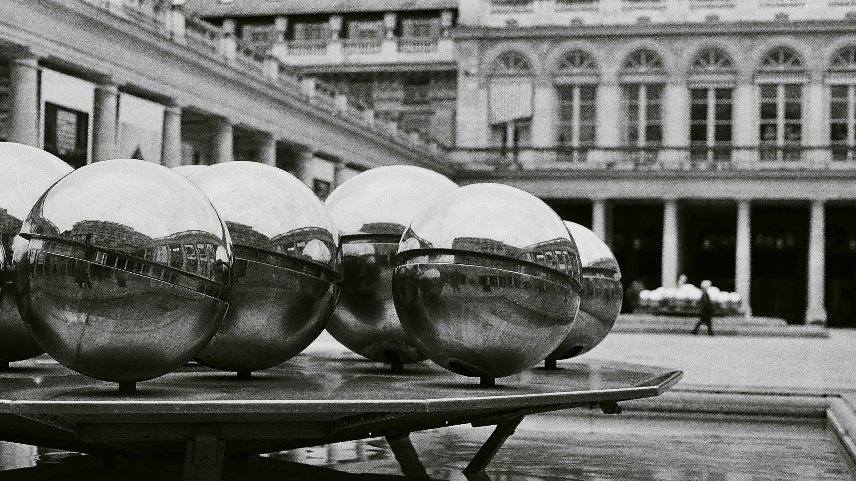 a black and white photo of some shiny balls on a table