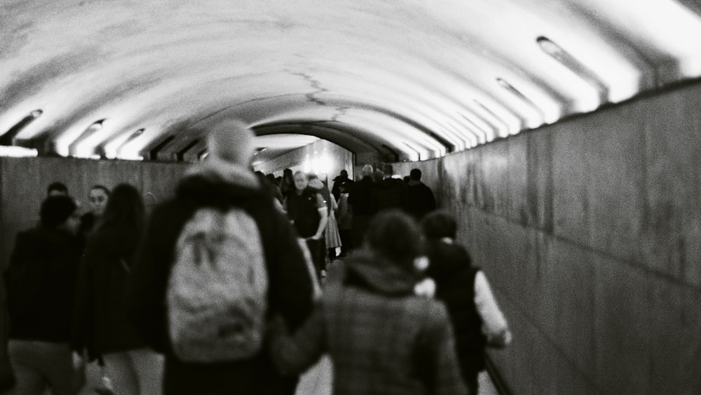 a group of people walking through a tunnel