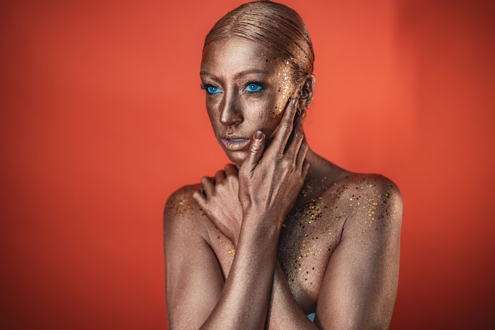 a woman with glitter on her face and body