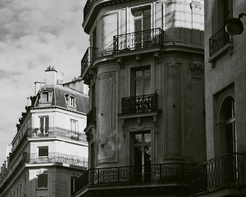 a black and white photo of a building with balconies