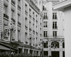 A detailed black and white photograph of an old city street with vintage charm.