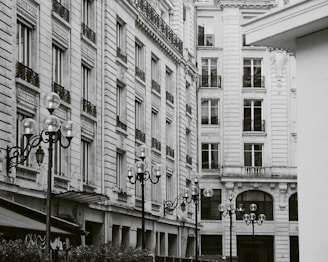 A black and white photo capturing a vintage Baltimore street scene with subtle fashion details.