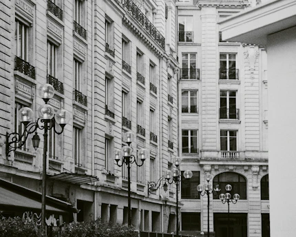 A detailed black and white photograph of an old city street with vintage charm.
