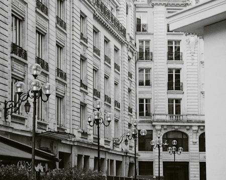 Black and white photo of a bustling street scene from early 20th century architecture district