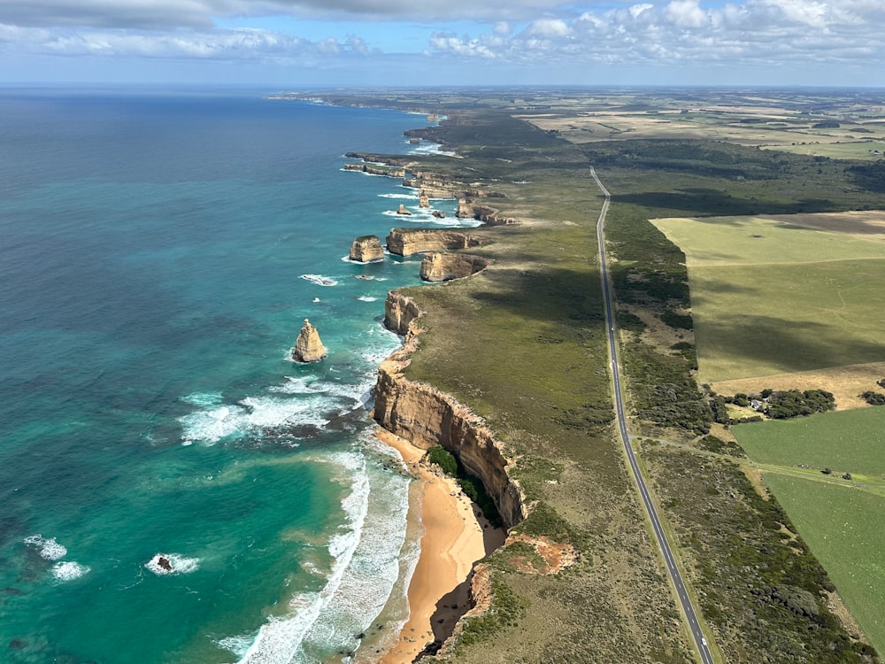 an aerial view of a highway near the ocean