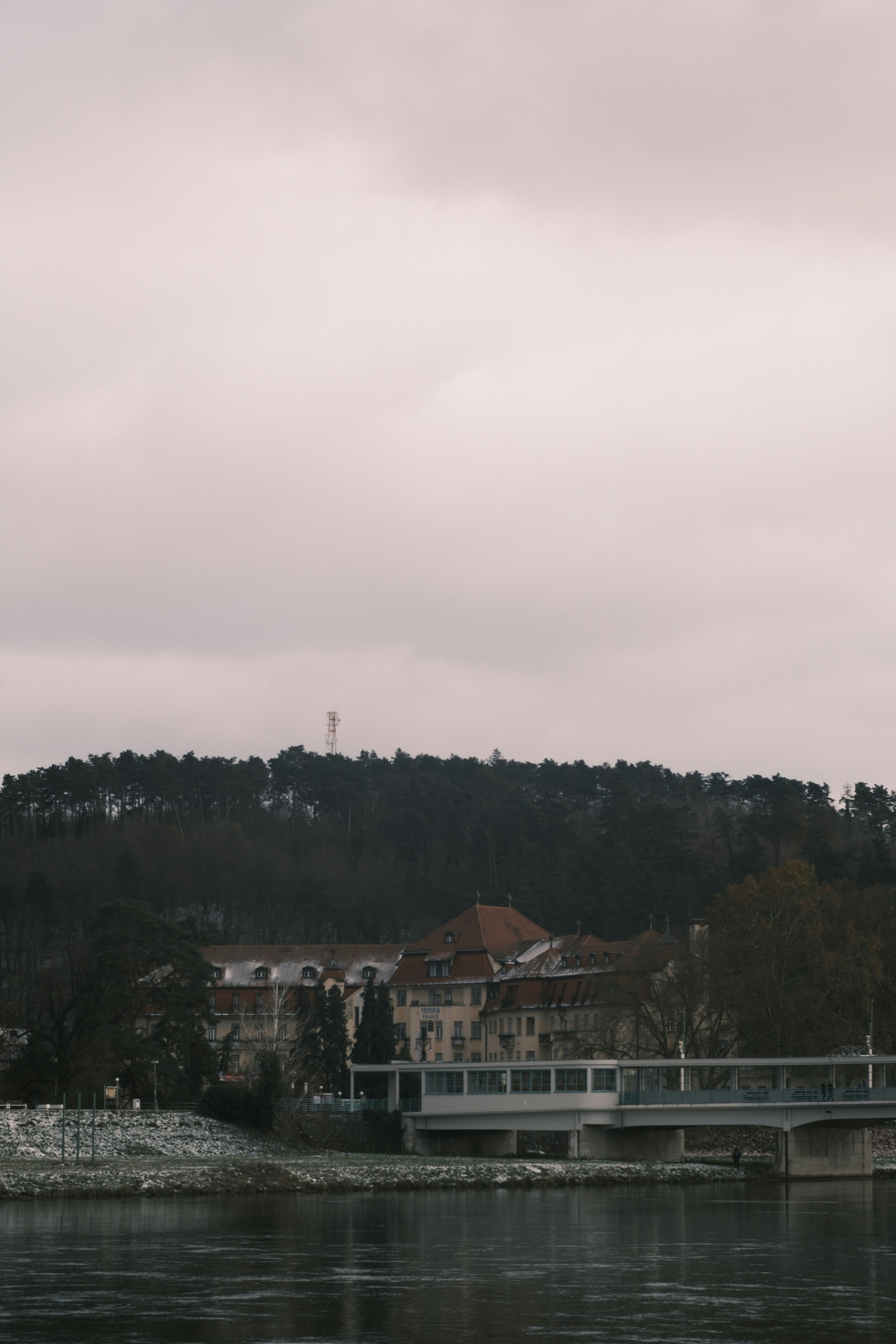 a bridge over a body of water with a building in the background