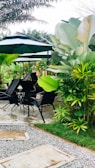 An outdoor dining setup surrounded by lush greenery.