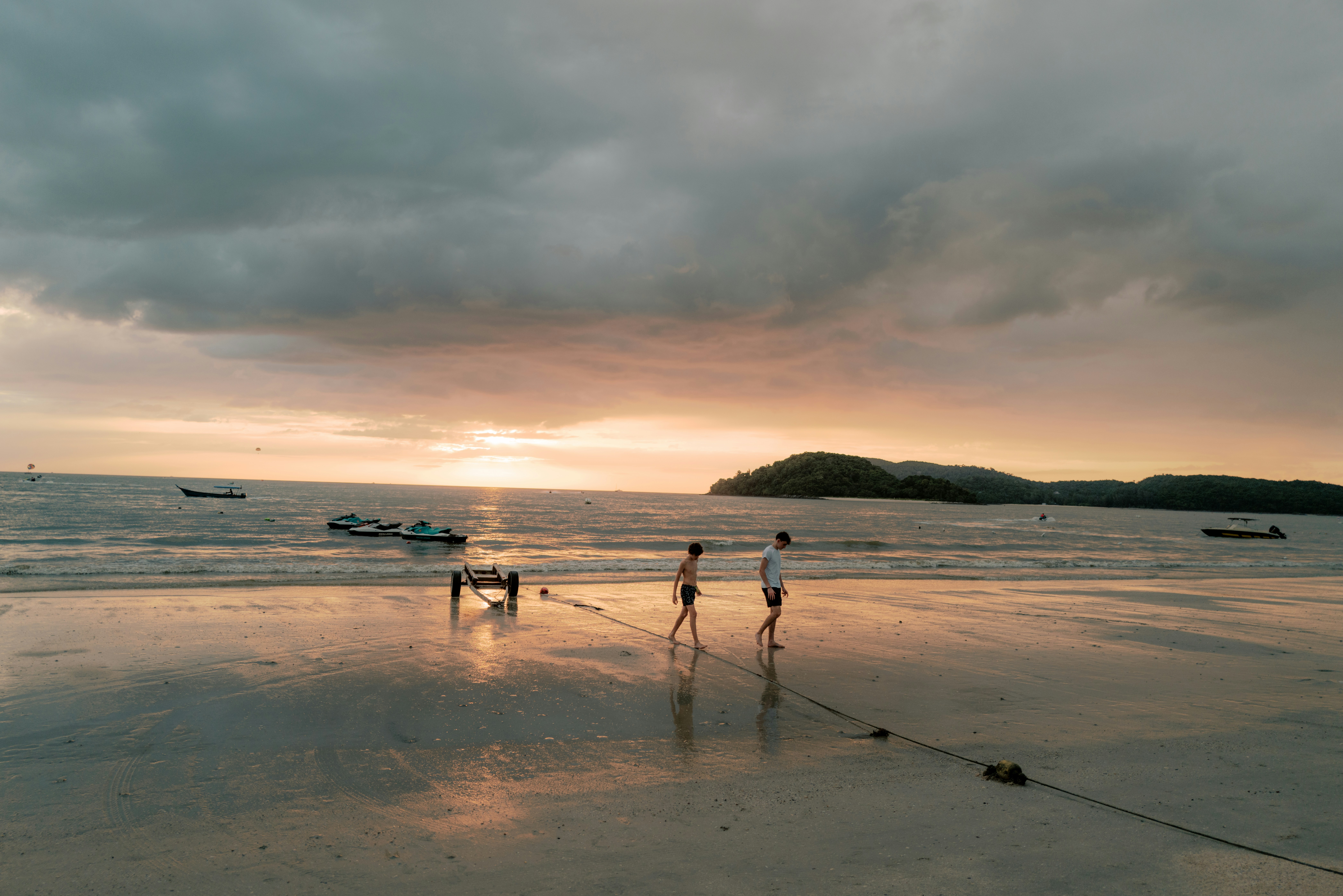 a group of people standing on top of a sandy beach