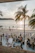 A warm sunset over the Atlantic as guests enjoy fresh seafood and drinks at an open-air beachfront grill.