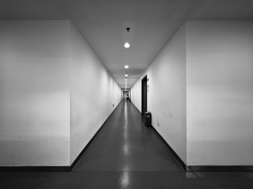 a black and white photo of a long hallway