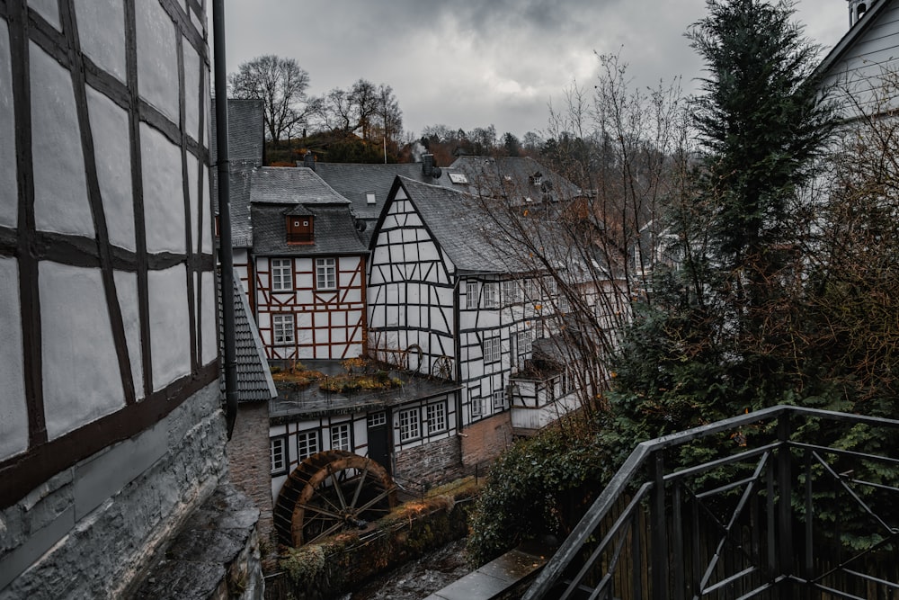 an old building with a water wheel in front of it