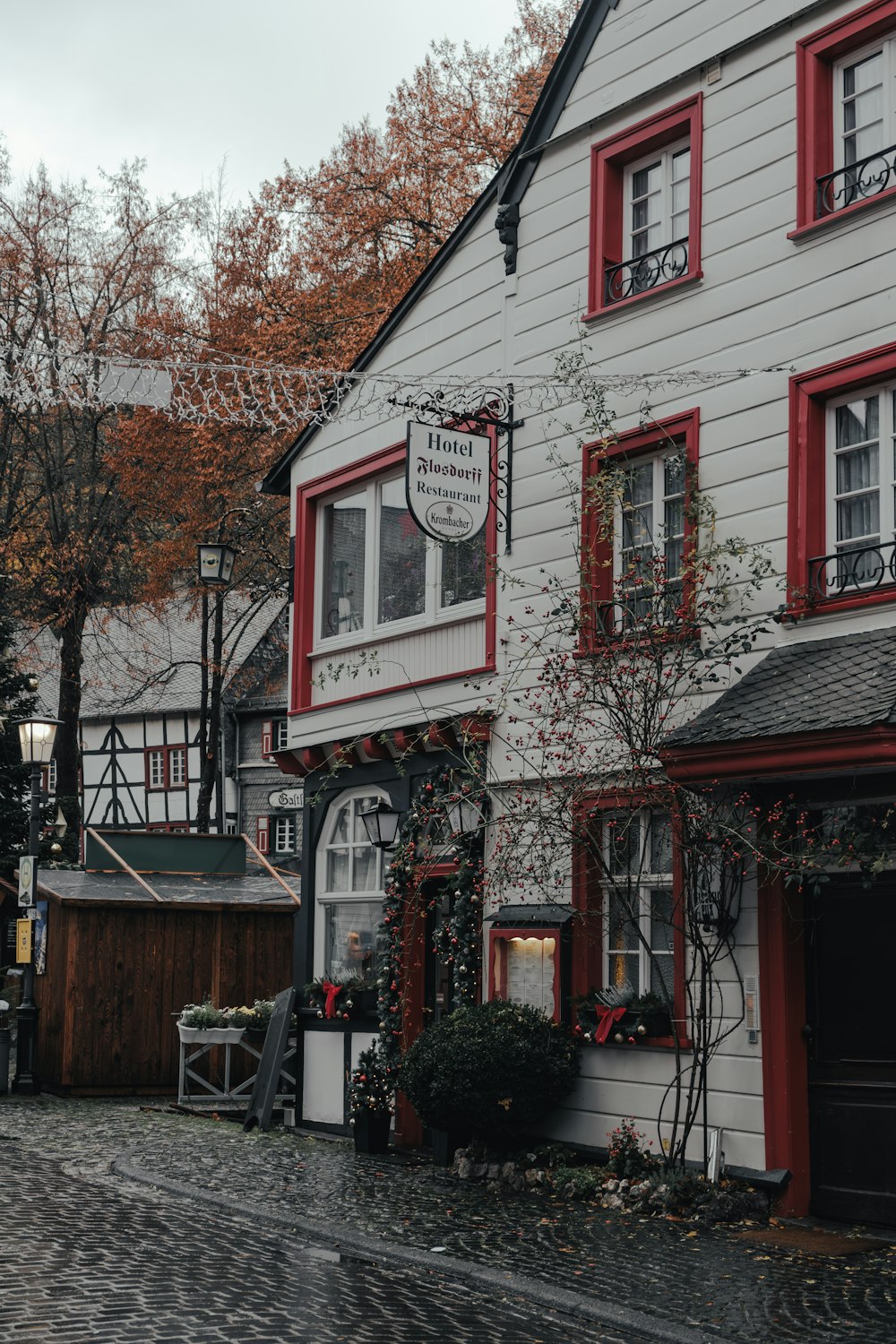 a white and red building with red shutters