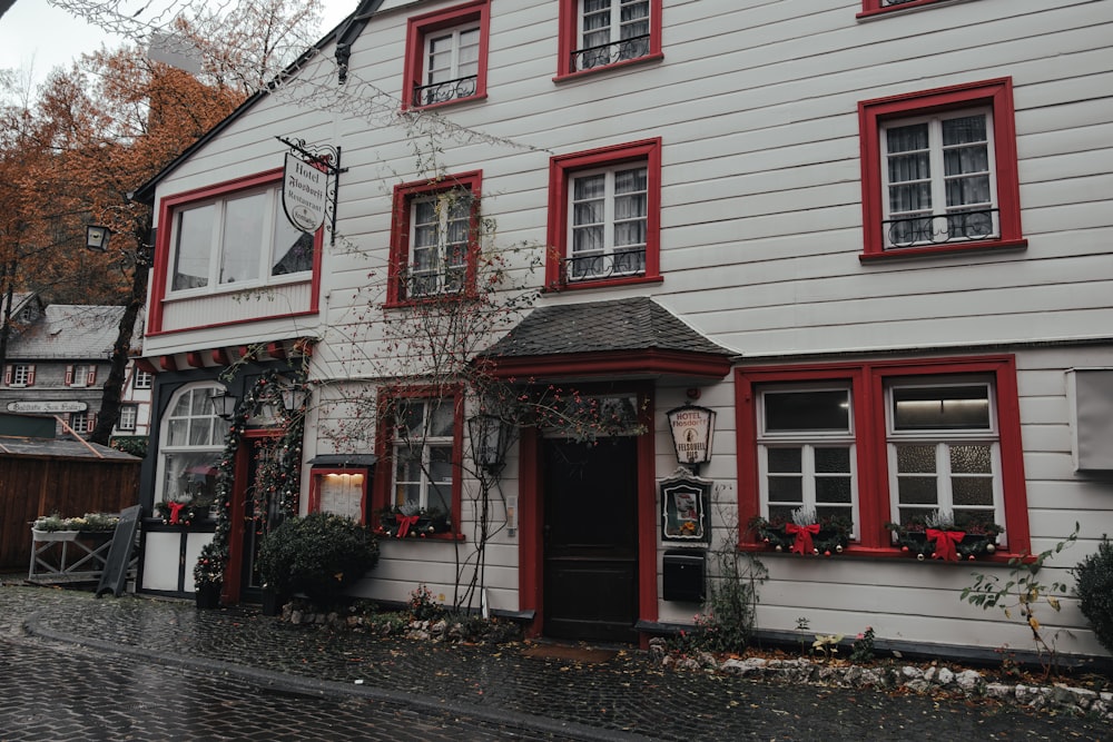 a white house with red trim and windows