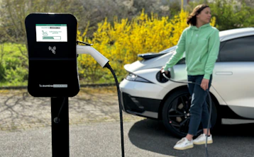 a woman standing next to a white car