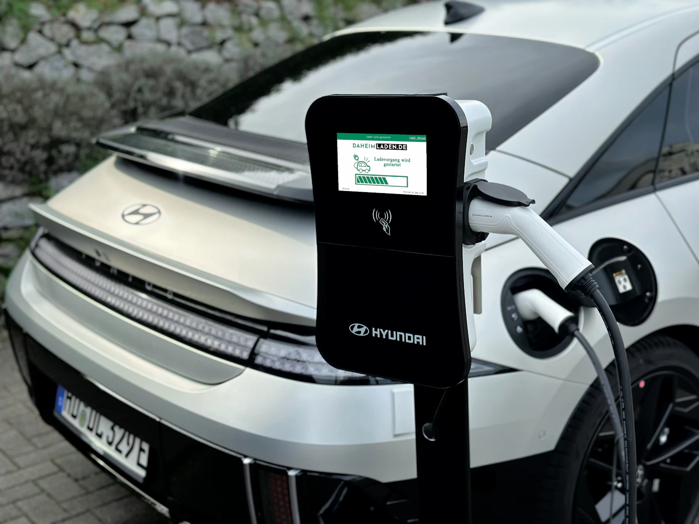 Electric car plugged in to a charging station