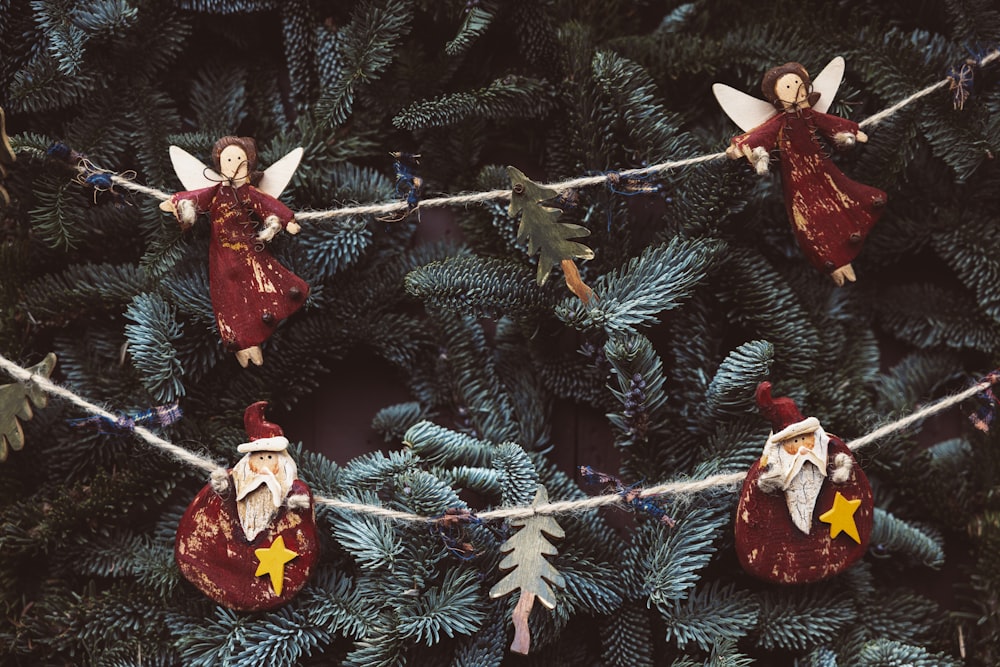 a group of christmas ornaments hanging from a rope