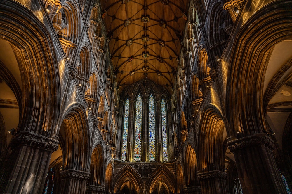 the interior of a cathedral with stained glass windows