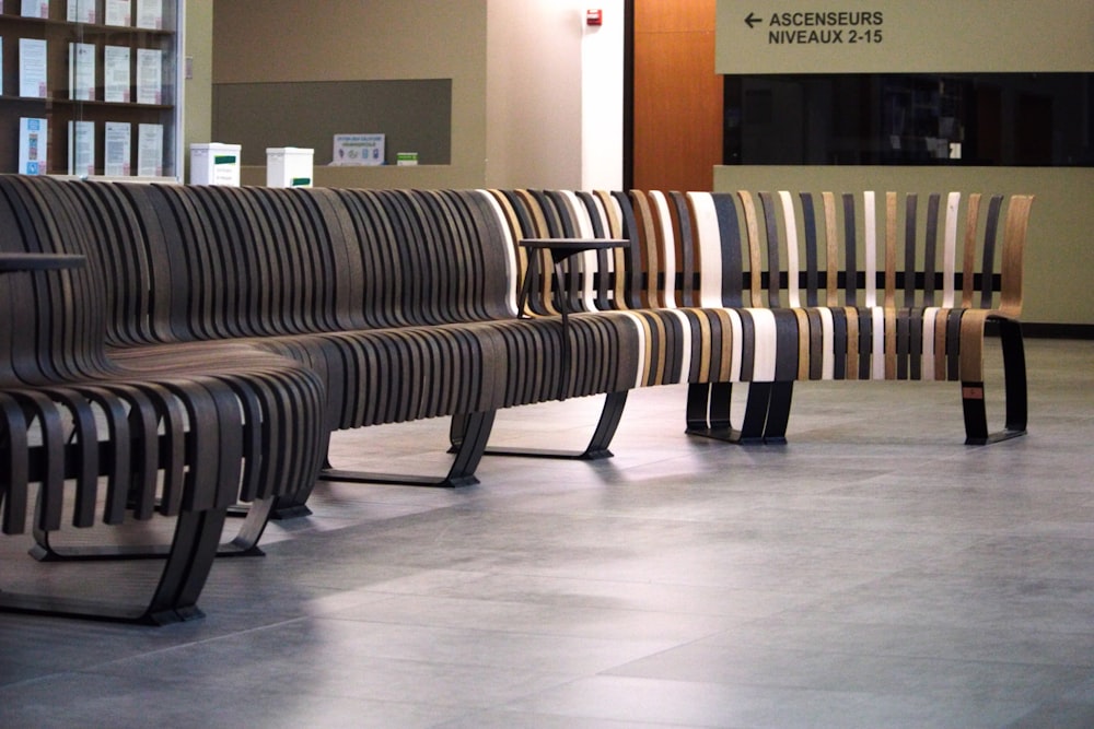 a row of benches sitting in front of a window