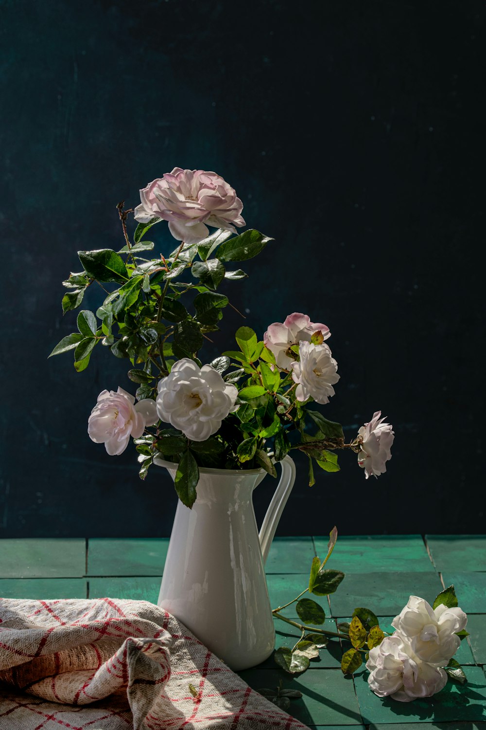 a vase of flowers sitting on top of a table