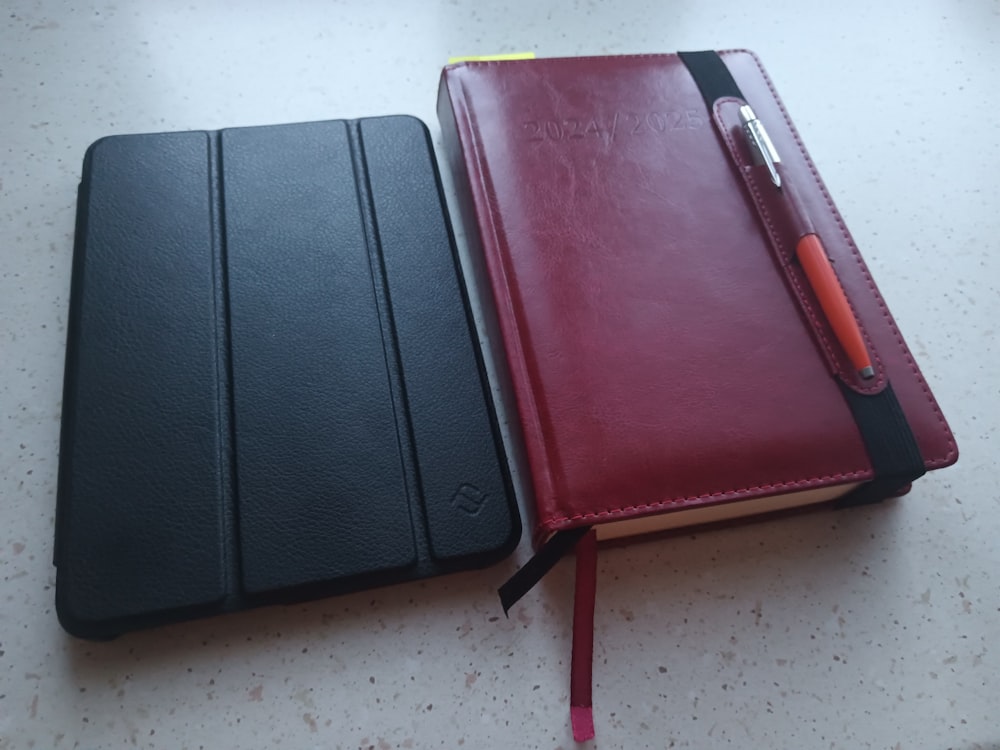 two notebooks sitting next to each other on a table