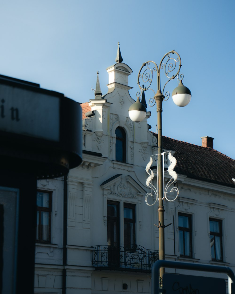 a street light with a building in the background