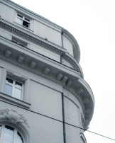 Close-up of elegant stonework and large glass windows on a luxury home.
