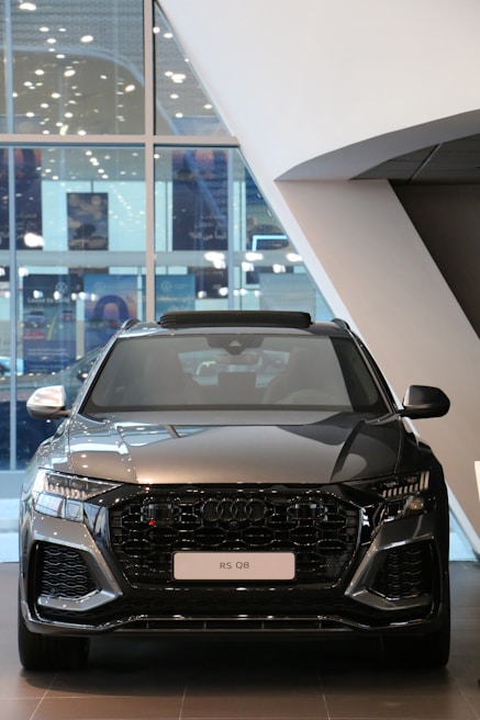 The Audi Q Drive launch event showcasing sleek cars with dynamic lighting