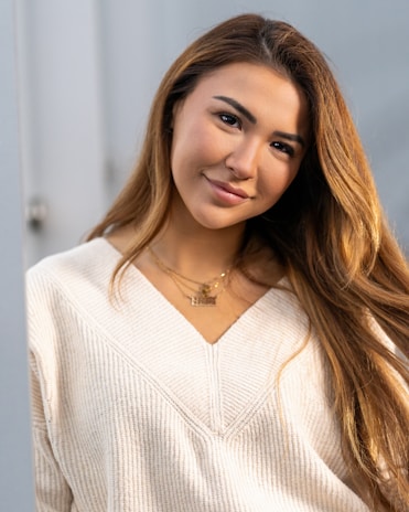 A casual outfit featuring a cozy sweater paired with layered necklaces from Golden Mkeys.