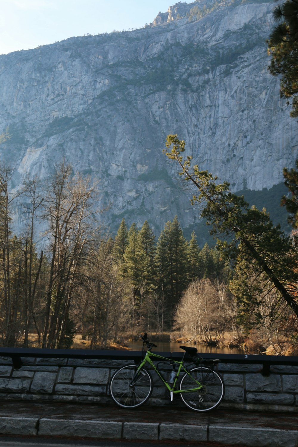 a bike parked on the side of a road near a mountain