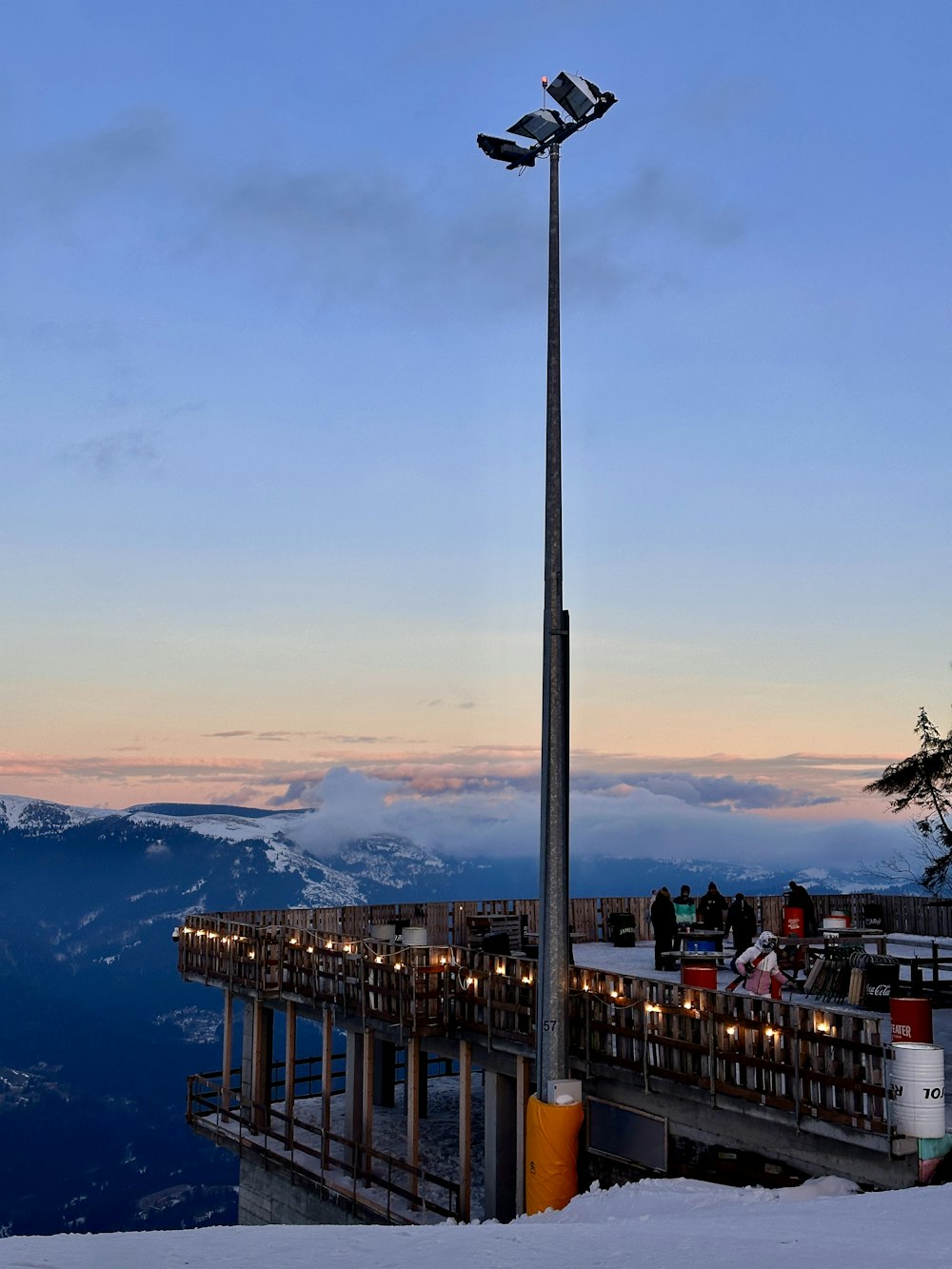 a street light on top of a snow covered hill