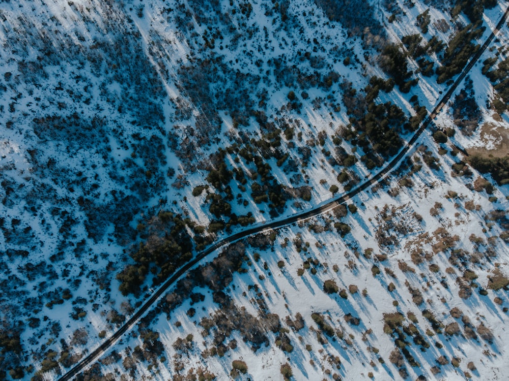 an aerial view of a road in the snow