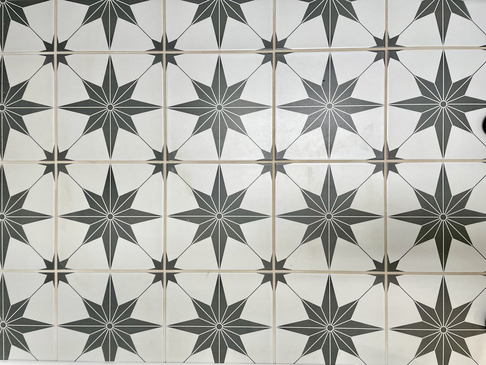 a black and white tiled wall with a star pattern