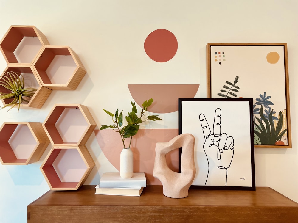 a shelf with a picture, a plant and a picture on it