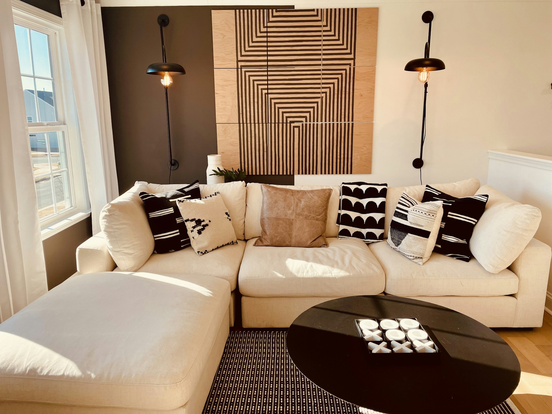 a living room with a white couch and a black coffee table