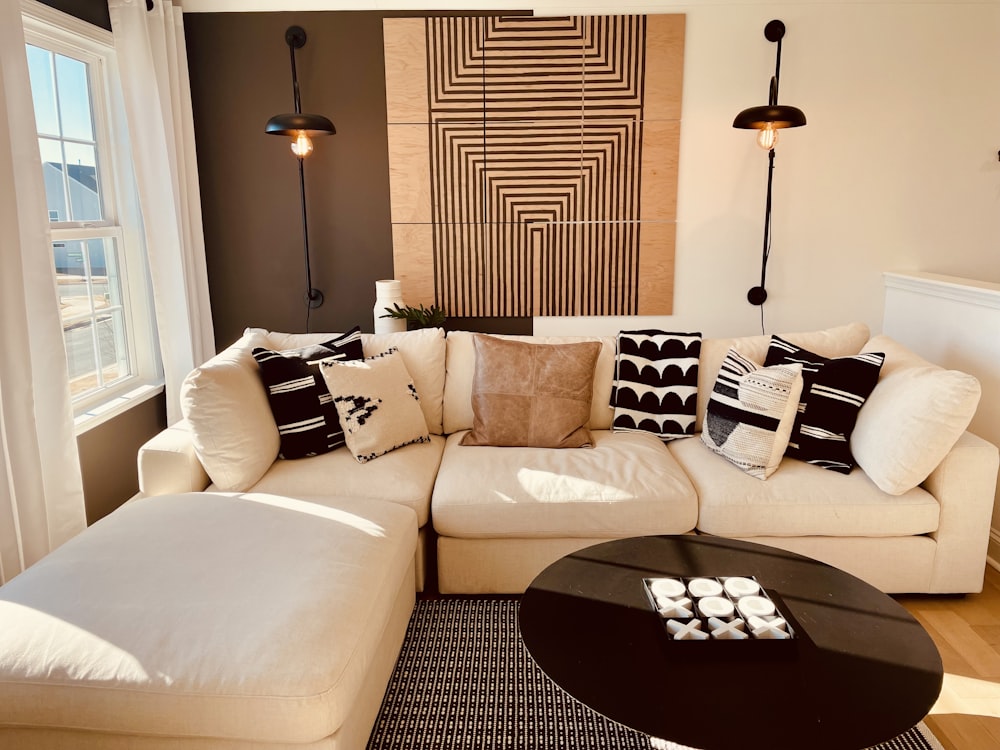 a living room with a white couch and a black coffee table