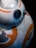 A close-up view of a spherical robot with a glossy black eye and intricate white and orange patterns. The mechanical design features circular elements and panels, suggesting a futuristic or sci-fi theme.