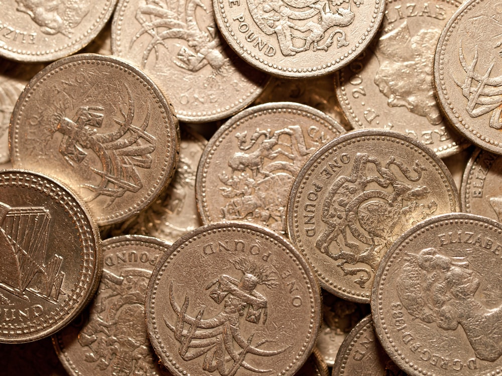 a pile of british coins sitting on top of each other