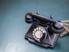 an old - fashioned rotary telephone sits on a table