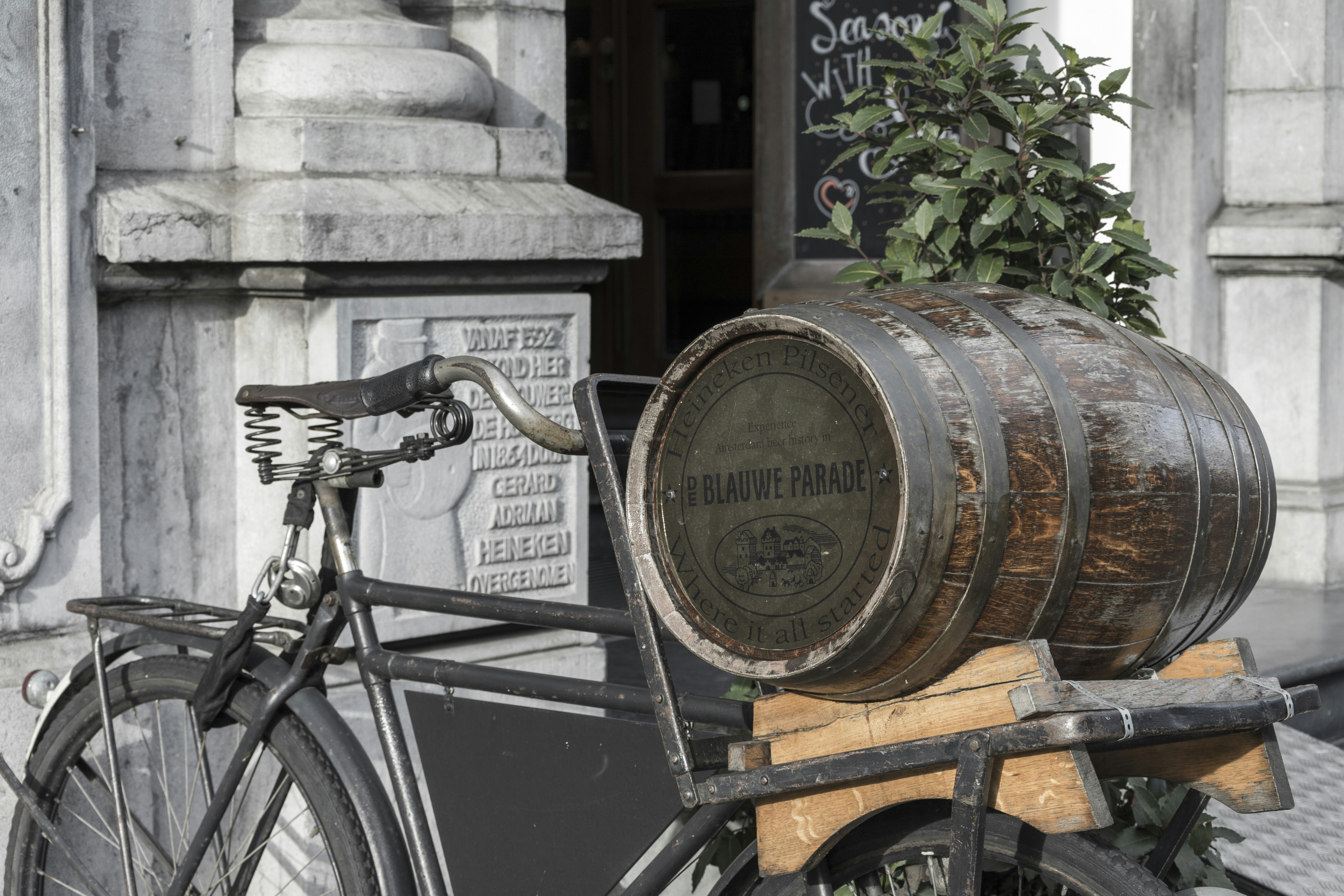 a bicycle with a wooden barrel on the back of it
