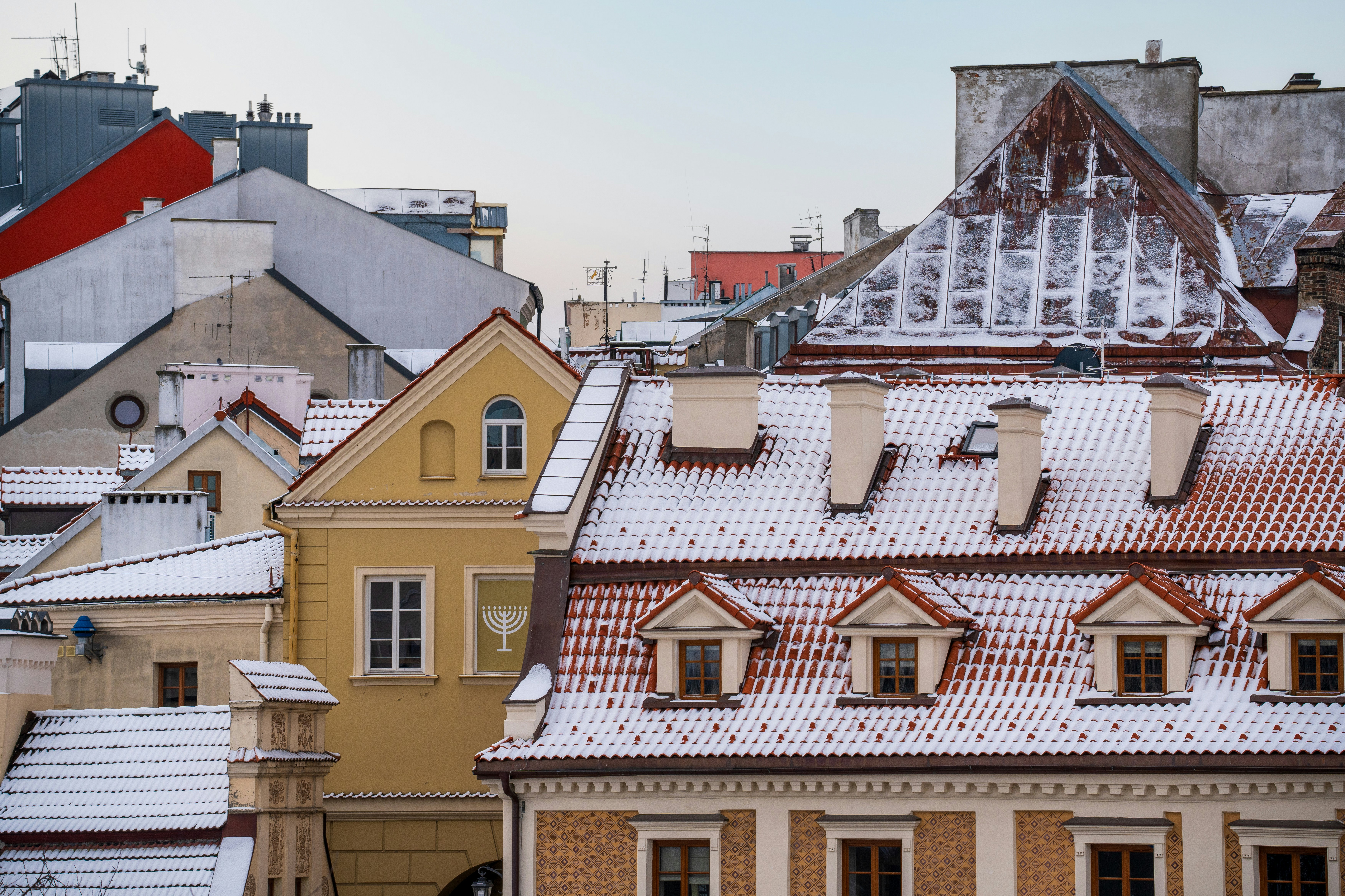 a view of rooftops with snow on them, 