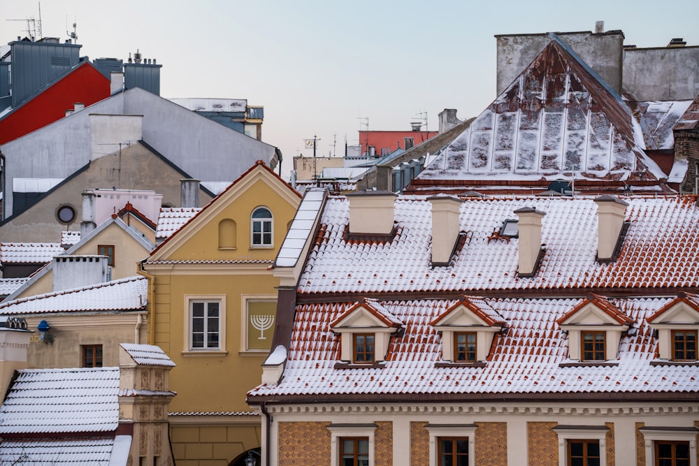 a view of rooftops with snow on them
