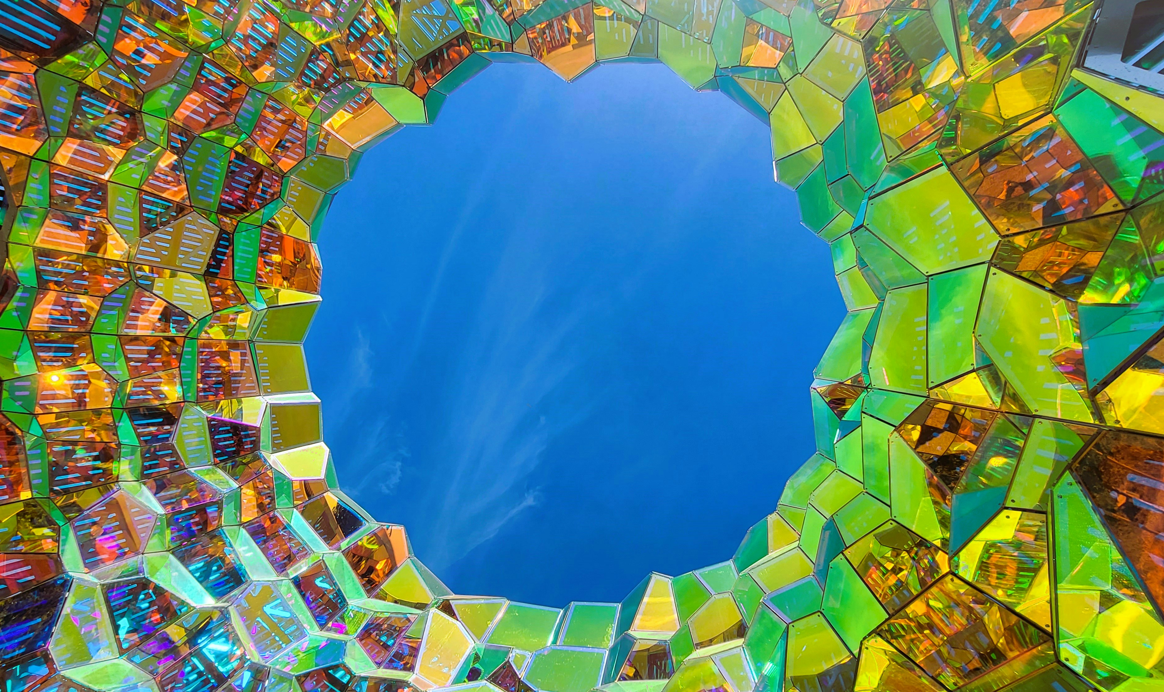A colorful mirror reflecting a blue sky and clouds photo – Free Google ...