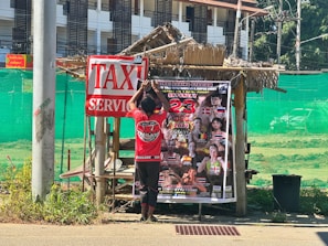 An old poster showcasing a Muay Thai match from the early 1900s with bold Thai script.
