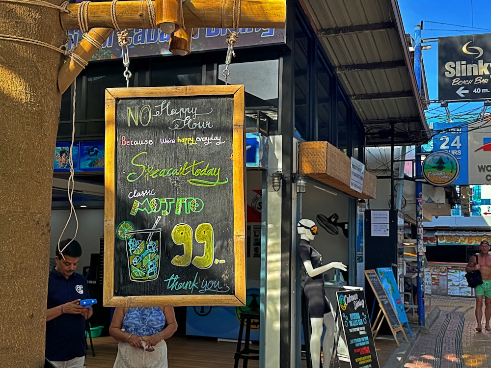 a woman standing in front of a store holding a sign