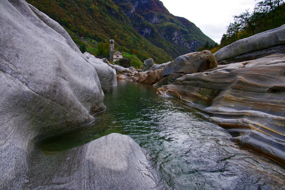 a river running between two large rocks in a valley