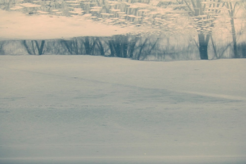 a man riding a snowboard down a snow covered slope