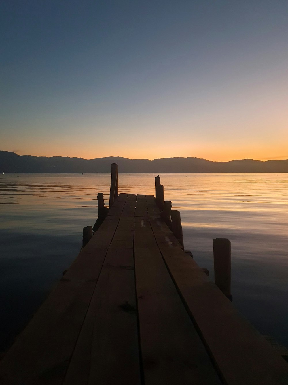 a wooden dock sitting on top of a body of water